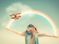 Happy kid playing with toy airplane